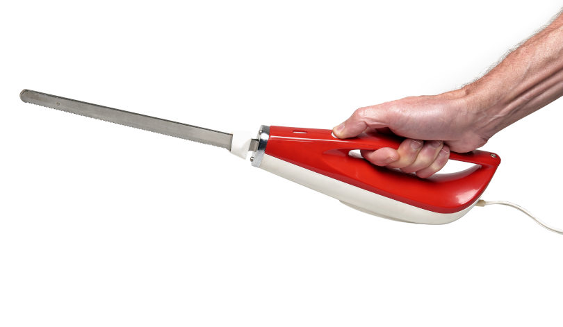 Man holding a vintage electric kitchen knife