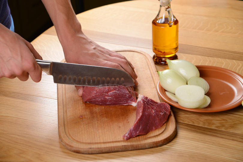 Beef steak, Pieces of raw meat with steak knife on a kitchen table