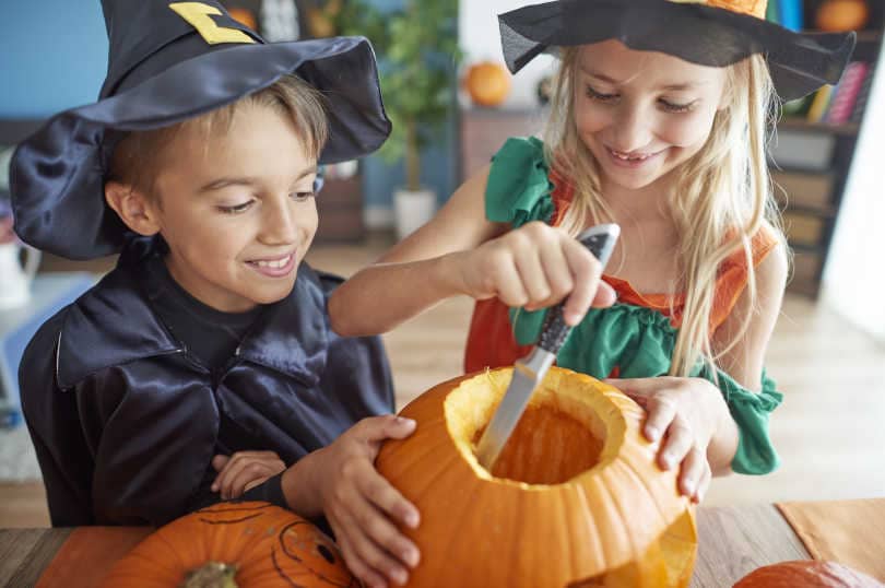 Kids preparing pumpkin for Halloween with their knife