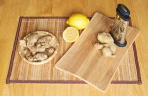 Ginger, lemon and grater composition on a board