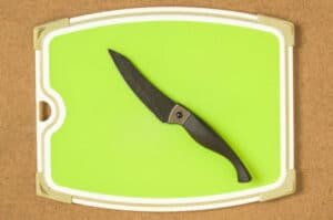 Rubber cutting board and knife on a wooden board