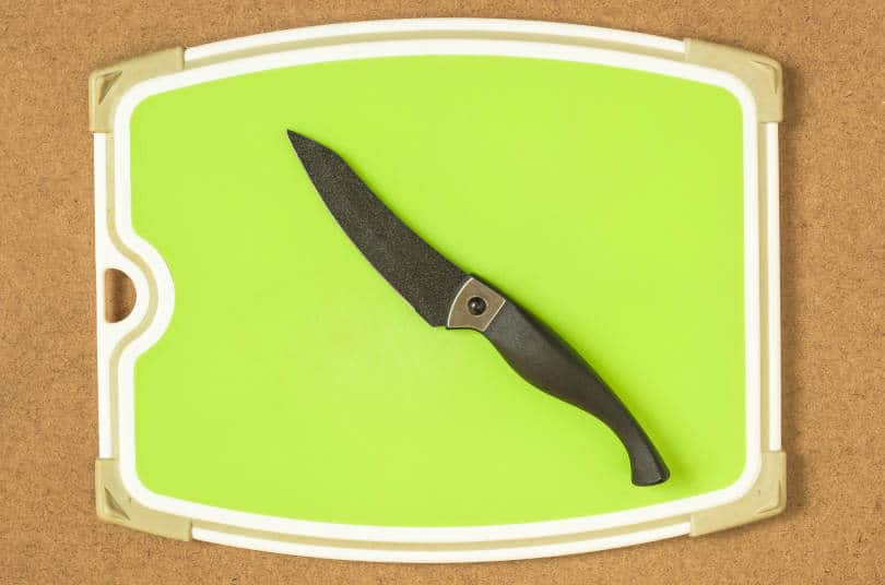 Rubber cutting board and knife on a wooden board