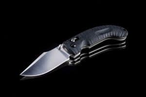 Sharp single blade pocket knife on a black background