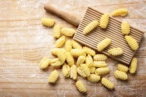 Durum wheat semolina gnocchi and gnocchi board on pastry board