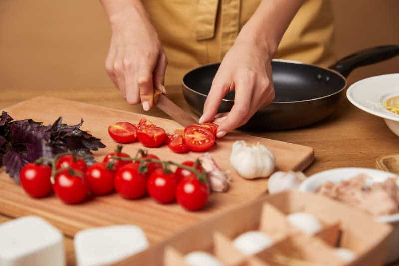 Cutting Tomatoes with Tomato Knife on a Cutting Board