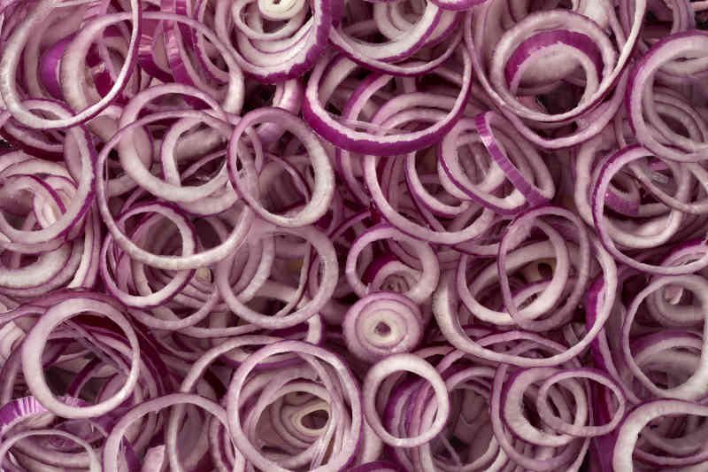 Fresh raw red onion rings full frame