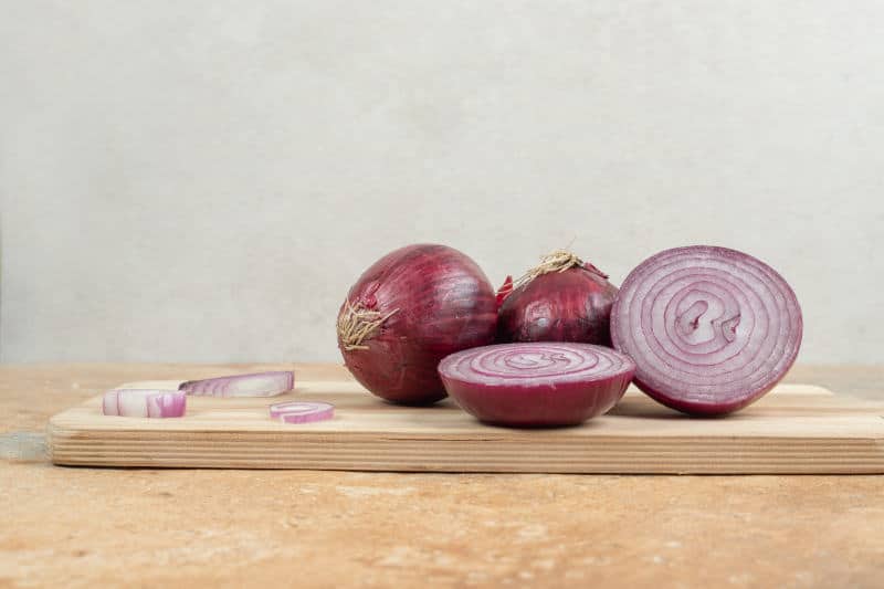 Sliced onion on a wooden cutting board