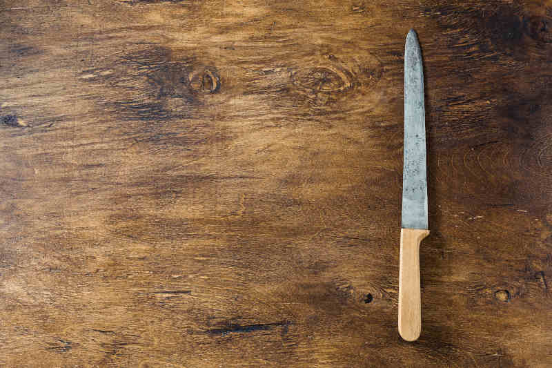 Vintage old knife on a wooden background